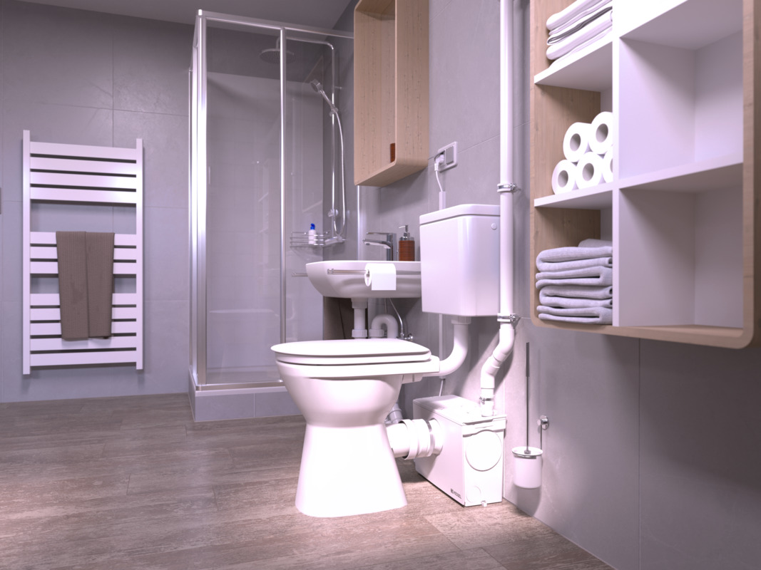 Nahaufnahme einer Toilette, hinter der eine Kleinhebeanlage steht, an die auch eine Dusche angeschlossen ist.